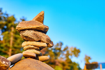 Stone tower on the seaside on the background of blue sky