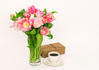 A cup of coffee with a gift and tulips, A gift for a woman on Mother's Day with a copy of the space