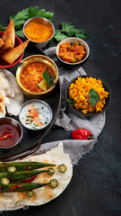 Indian Thali on dark background.