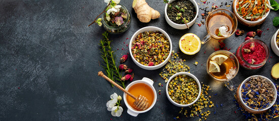 Herbal tea assortment on dark background.