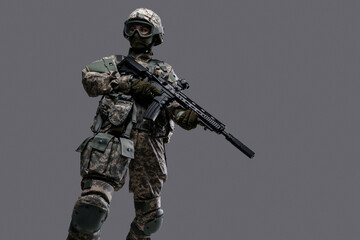 Photo of professional servicewoman holding rifle dressed in camouflage uniform.