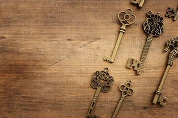 Top view image of old keys over wooden background