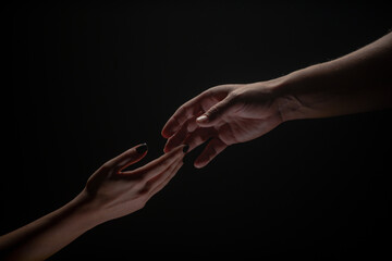 Two hands. Helping hand to a friend. Rescue or helping gesture of hands. Concept of salvation. Hands of two people at the time of rescue, help. Isolated on black background.