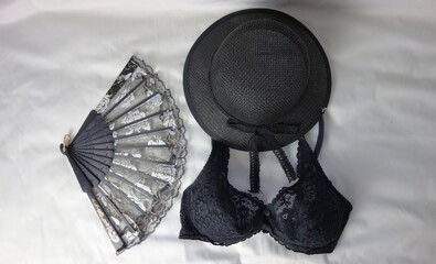 black bra, black hat and black fan isolated on grey background