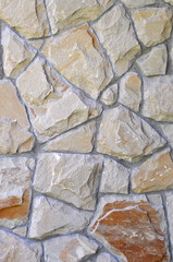 Exterior wall  of broken granite stone in gray-brown tones. Wall pattern. Wall  natural stone cladding   background.