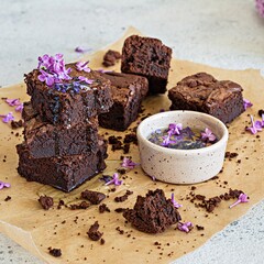 Chocolate brownie with lilac flower syrup. Traditional American dessert.