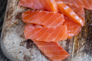 cutting fish fillets during the preparation of a dish of red salmon fish