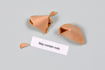 Food allergy concept. Fortune cookie with text 'may contain nuts'