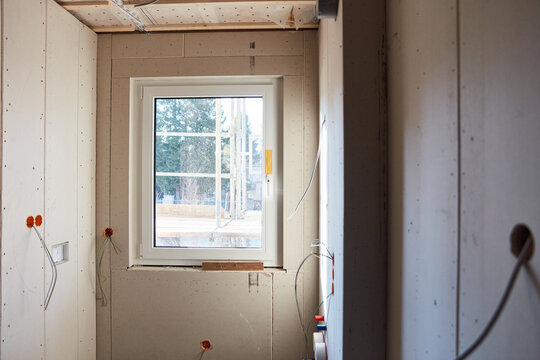 New window in construction site when building a house from a new building