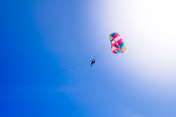 Parasailing in blue sky. Sports, active leisure, travel, vacation concept