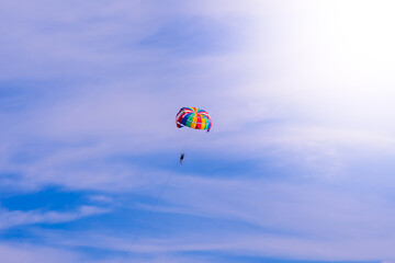 Parasailing in blue sky. Sports, active leisure, travel, vacation concept