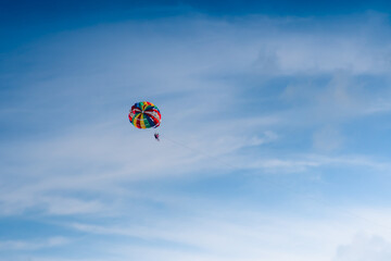 Parasailing in blue sky. Sports, active leisure, travel, vacation concept