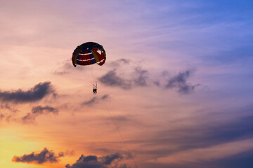 Parasailing in blue sky. Sports, active leisure, travel, vacation concept