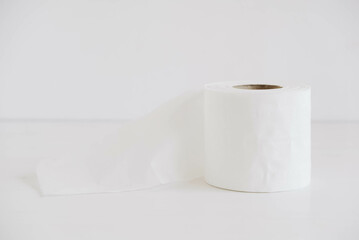 Roll of white toilet paper on a white background
