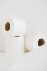 Rolls of white toilet paper on a white background