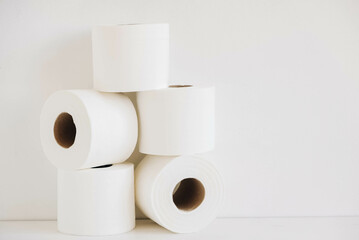 Rolls of white toilet paper on a white background