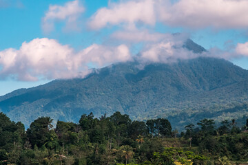Mountain among clouds and blue sky