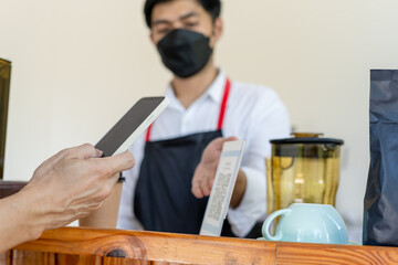 People scanning for pay for coffee and cake on cafe and collect point online by QR code. Mobile scanning online for pay on situation social distance . New normal.