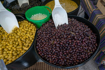 Green marinated olives on Mediterranean market.