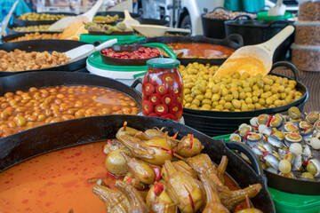 Green marinated olives on Mediterranean market.