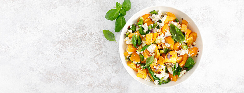 Yellow tomato salad with green paprika, cottage cheese and basil. Healthy food, diet. Top view. Banner