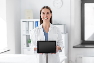 medicine, healthcare and profession concept - smiling female doctor showing tablet pc computer with...