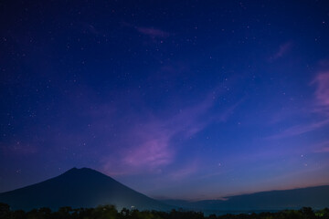 Silhouette of a mountain under milky way in the night sky