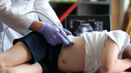Medical examination of little girl using ultrasound equipment - obrazy, fototapety, plakaty