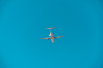 Business jet in blue sky. Travel, air transportation concept