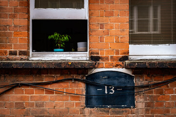 number 13 written on old building with windows