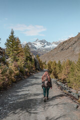 Fototapeta na wymiar Woman hiking in the mountains in Zermatt.