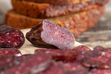 sliced piece of cured sausage on the table