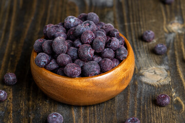 frozen blueberries on a wooden table