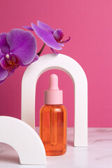 Fototapeta na wymiar Beauty collagen face oil in a glass dropper bottle in arch. Trendy shoot of cosmetics packaging. Essential oil with natural ingredients.