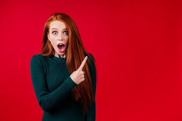 redhair ginger woman finger pointing copy space new year sale