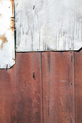 part of a building made of metal sheets that have oxidized and started to rust