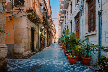 Characteristic alleyway with plants in the historic centre of Ortigia, Syracuse