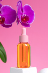 Obraz na płótnie Canvas Mock-up of glass bottle on pink background. Pink orchid flowers are located next to bubble, with oil. Concept of skin care, spa treatments, natural cosmetics.
