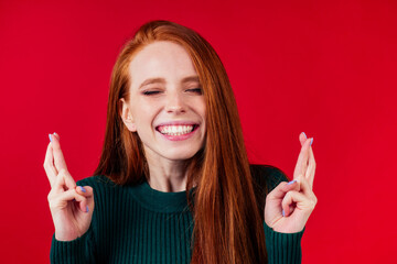happy redhair ginger woman in studio background feeling heart thanks