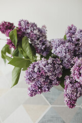 Home interior decor, bouquet of lilacs in a vase on table