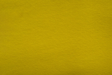 Macro yellow paper with visible texture. Textured background made of yellow cardboard paper. Yellow paper background