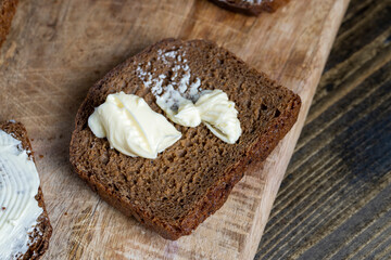 slices of black sliced bread with butter spread from milk
