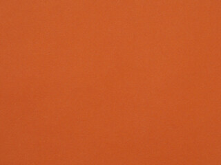 The texture of the dark orange color of the paper as a background