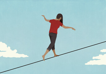 Barefoot woman walking along tightrope in sky
