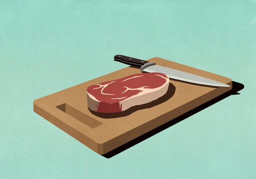 Raw steak on cutting board with knife
