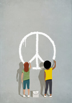 Multiracial girls painting peace sign on wall
