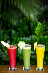 organic mixed fresh fruit juice glasses on cafe table
