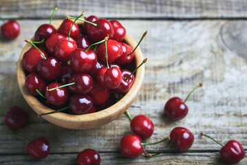 Fresh cherry fruit. Fresh red cherries fruit on rustic wooden table.