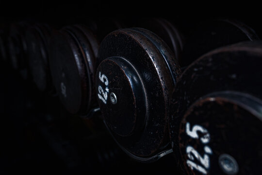 Metal weights dumbbells with white weight numbers, close up