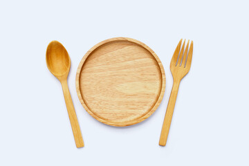 Wooden plate with spoon and fork